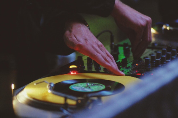 Foto close-up di un dj di un club che suona musica su un giradischi