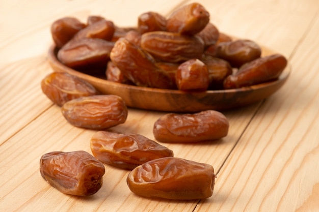 Close up of cluster dates plam. Fresh dates plam on wooden table.