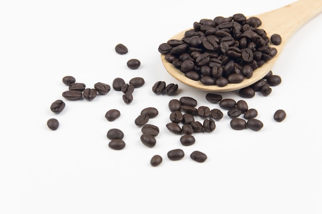 Close-up coffee bean on wooden spoon isolated 