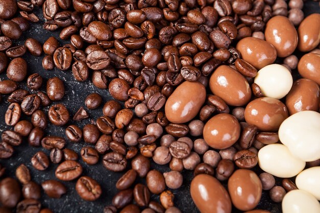 Close up of coffee beans and peanuts in chocolate mixed