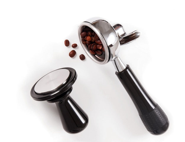 Close-up of coffee beans and portafilter on table