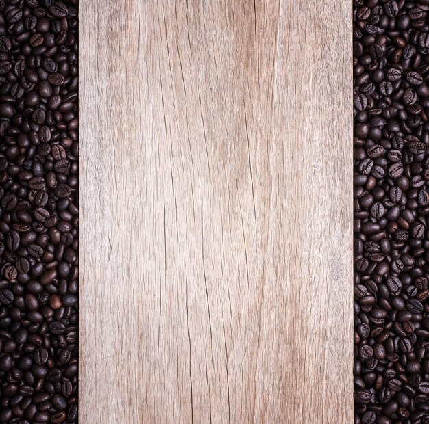 Close up coffee beans on wooden background, Composition with free space of wood