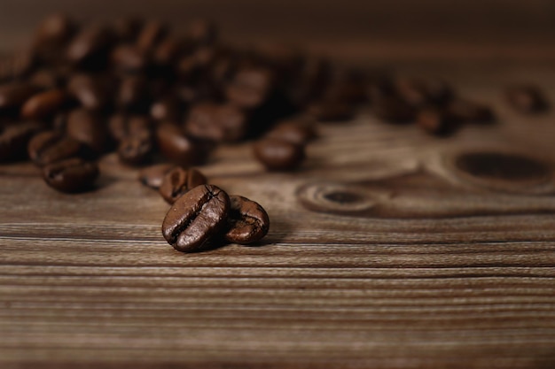 close up of coffee beans on wooden background