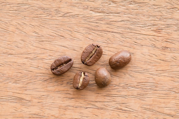 木製の机の上にコーヒー豆のクローズアップ