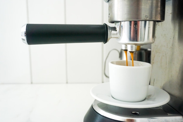 Close-up of coffee cup on espresso machine