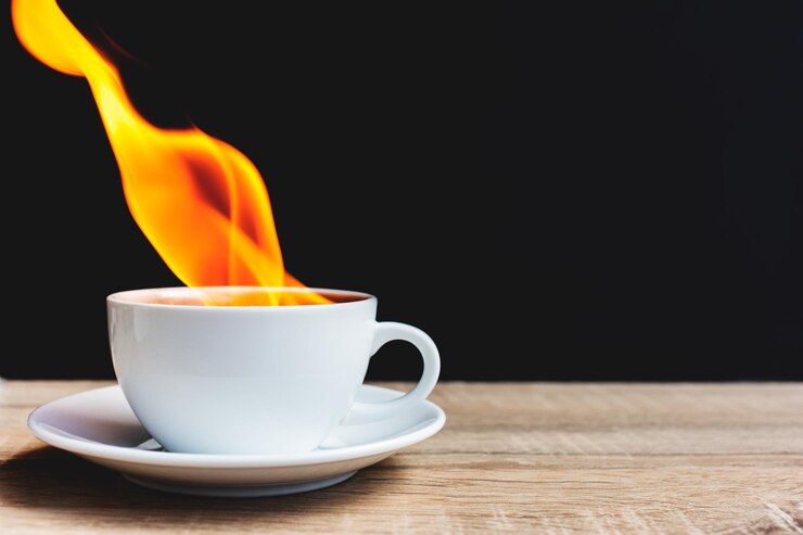 Photo close-up of coffee cup on table against black background
