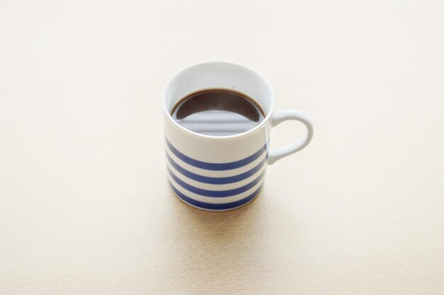 Close-up of coffee in cup on table against on table