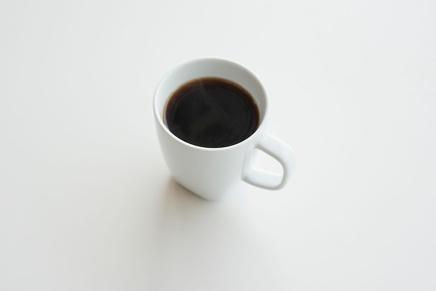 Close-up of coffee cup over white background