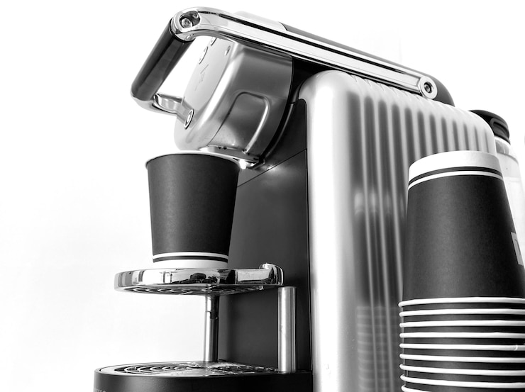 Photo close-up of coffee machine against white background