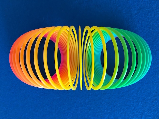 close-up of coiled spring toy on blue fabric