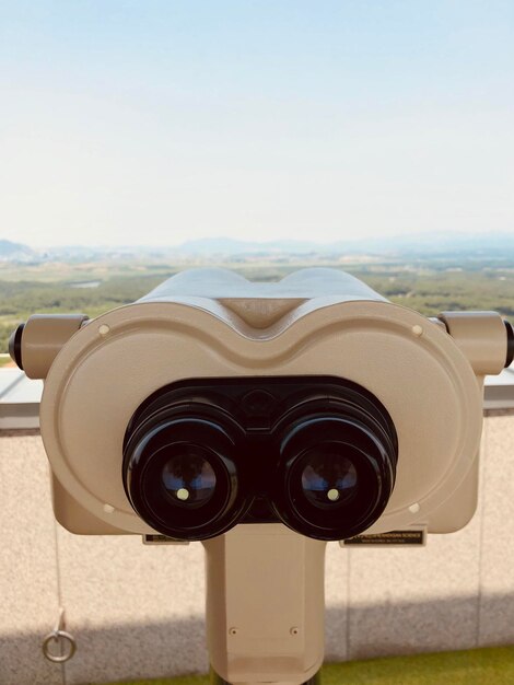 Photo close-up of coin-operated binoculars against clear sky