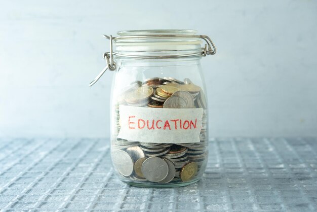 Close-up of coins in glass jar on table