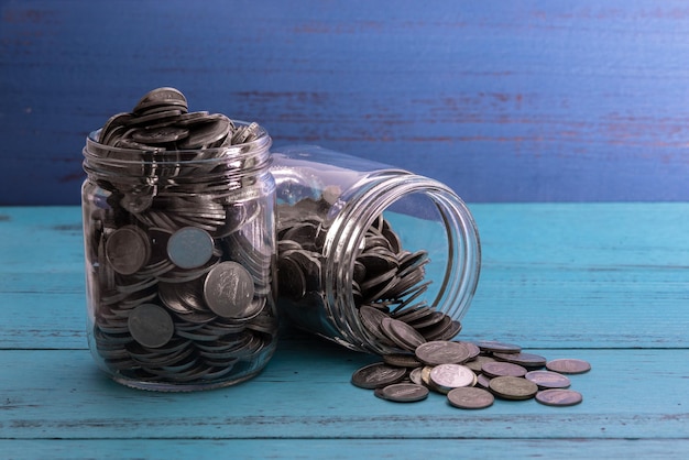 Close-up of coins in jar on table