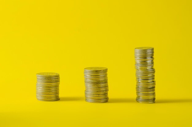 Close-up of coins on yellow background