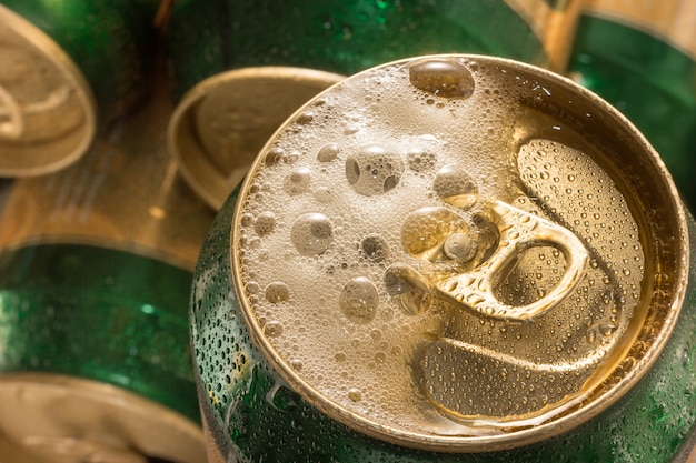 Close up cold  can beer with foam bubble.