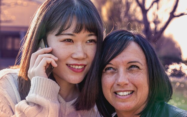 Close-up of colleague talking on phone outdoors