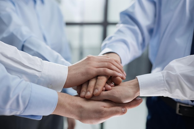 Close up on colleagues hands all together