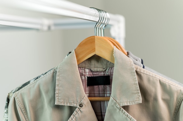 Close up collection Hangers with clothes on rack in wardrobe