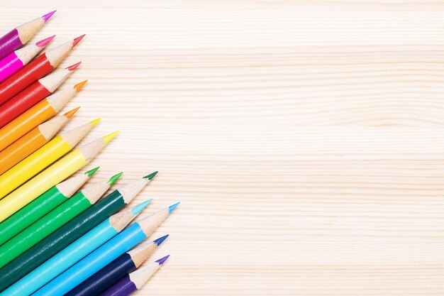 Close up of color pencils pile pencil tipped nibs put lined on the desk wooden