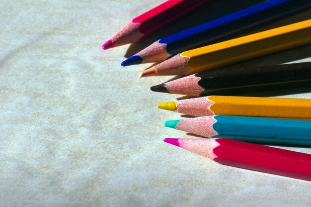 Close up of color pencils with its shadow on the floor