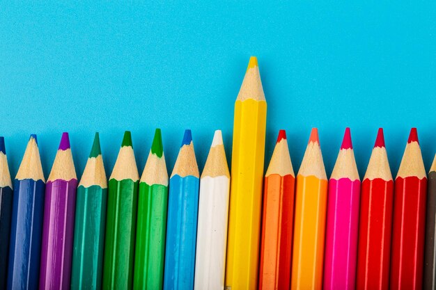 Close-up of colored pencils against blue background