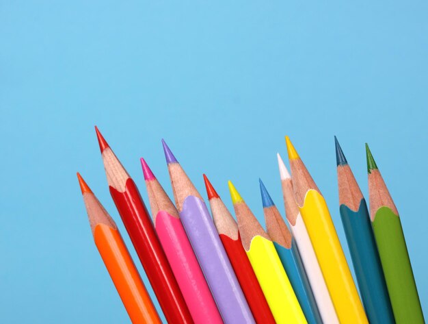 Close-up of colored pencils against blue sky