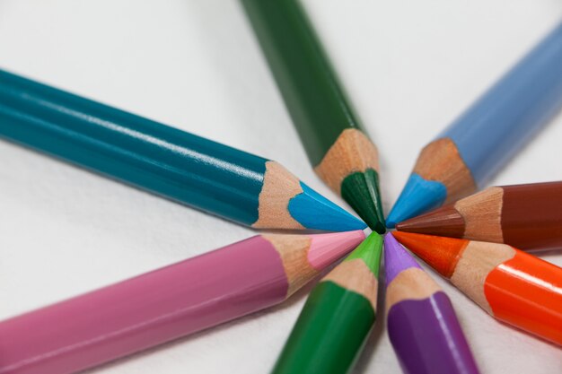 Close-up of colored pencils arranged in a circle