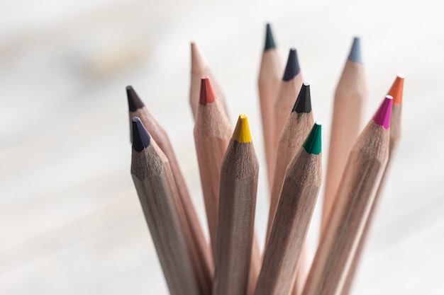 Close up of colored pencils for drawing on blurred surface