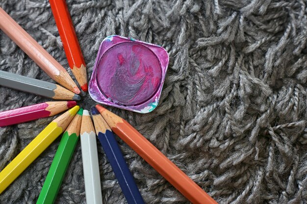 Close-up of colored pencils on rug