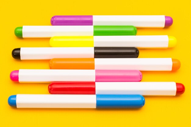 Close-up of colored pencils over white background