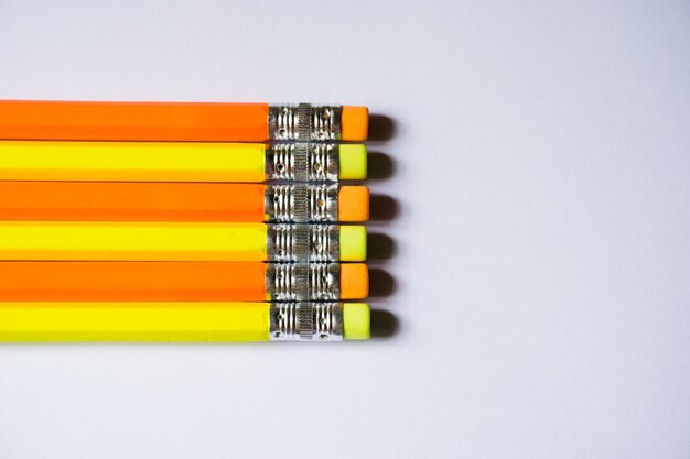 Close-up of colored pencils over white background