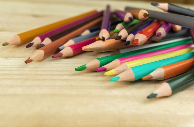 Close up of colored pencils on a wooden surface