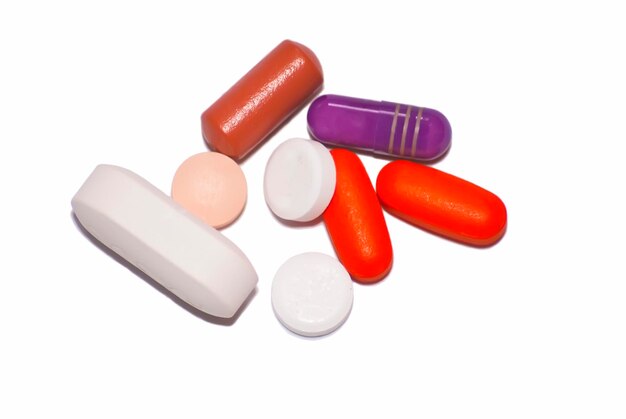 Photo close-up of colored pills on white background