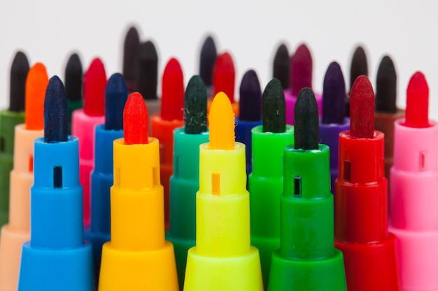 Photo close-up of colorful colored pencils over white background