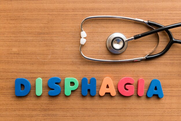 Close-up of colorful dysphagia text with stethoscope on wooden table