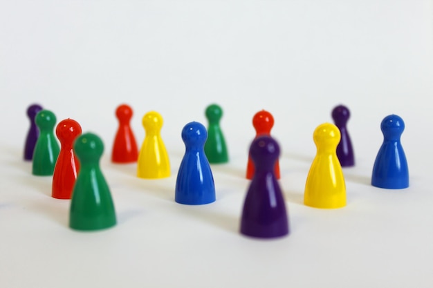 Photo close-up of colorful game tokens over white background