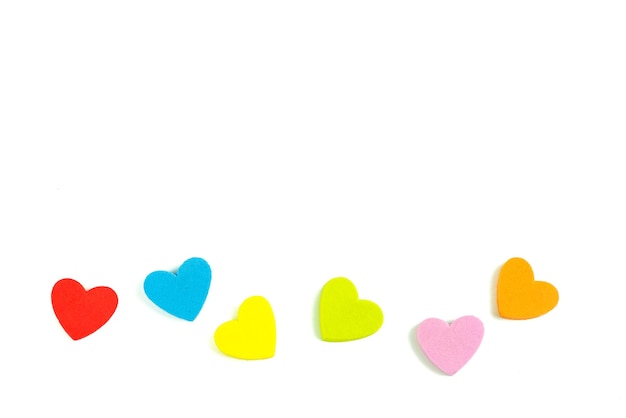 Close-up of colorful heart shaped decorations on white background