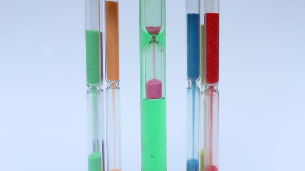 Photo close-up of colorful hourglass on white background