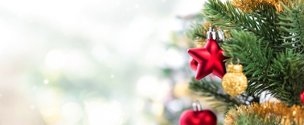 Close up of colorful ornaments on Christmas tree, panoramic banner background