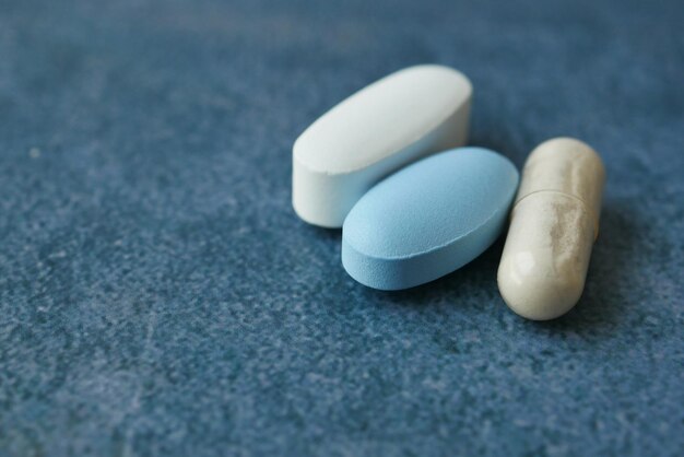 Close up of colorful pills and capsules on black background