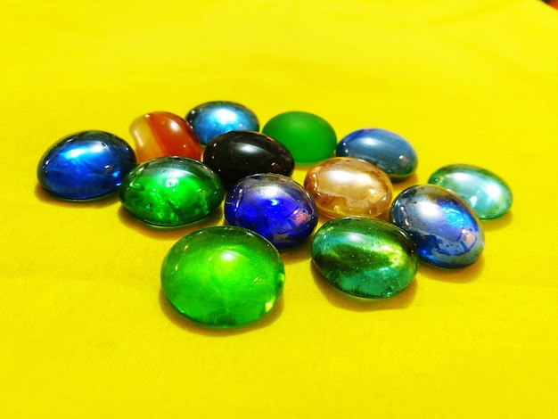 Close-up of colorful stones on yellow background