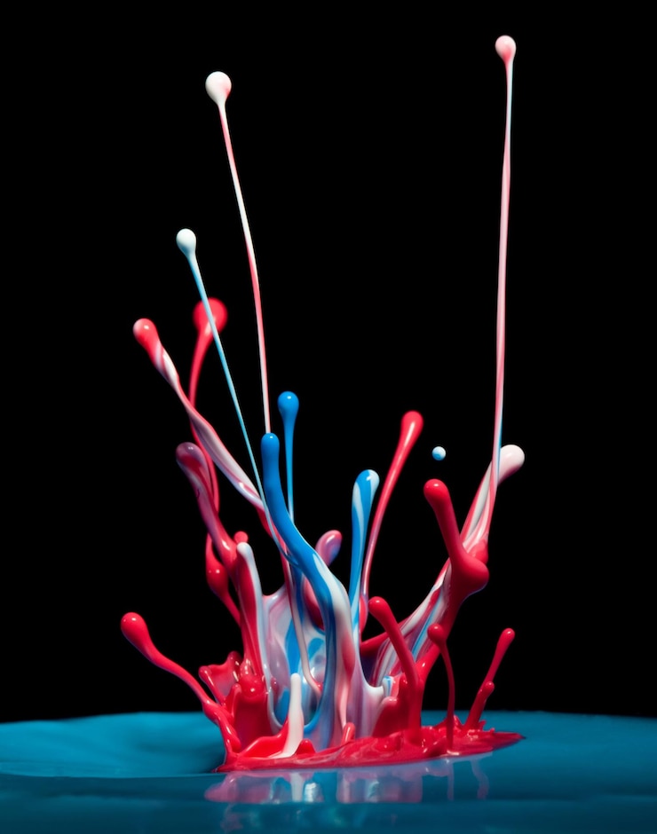 Photo close-up of colorful water splashing against black background