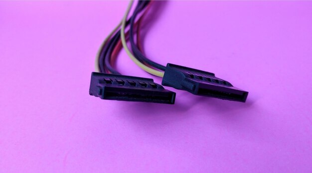 Photo close up of computer cable isolated on pink background with copy space