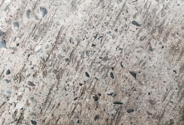 A close up of a concrete floor with pebbles