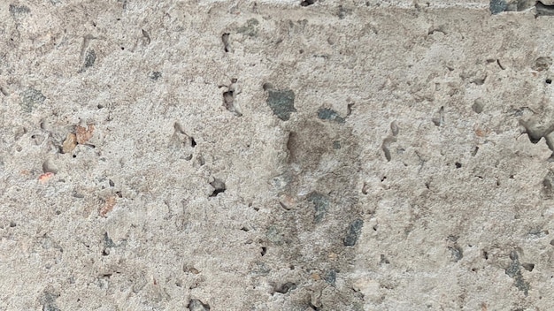 A close up of a concrete slab with a black stain on it.