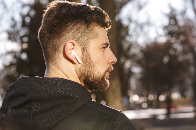 close up of a confident young sportsman in earphones