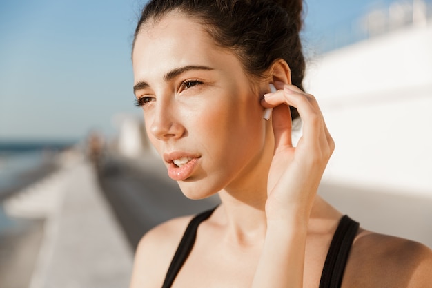 Close up confident young sportswoman at the seaside