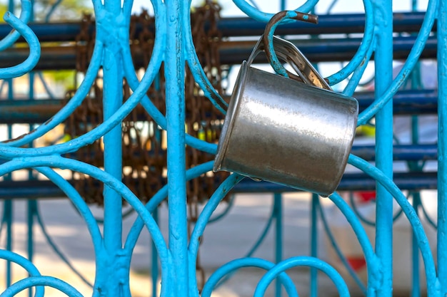 Close-up of container hanging on gate