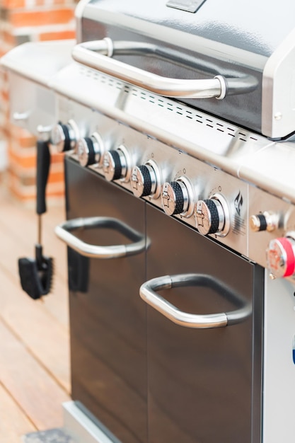 Close up of control knobs on outdoor 6 burner gas grill.