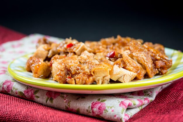 Close-up of cooked chicken in plate on tablecloth